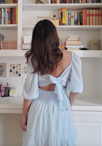reviewer wearing the tie back dress