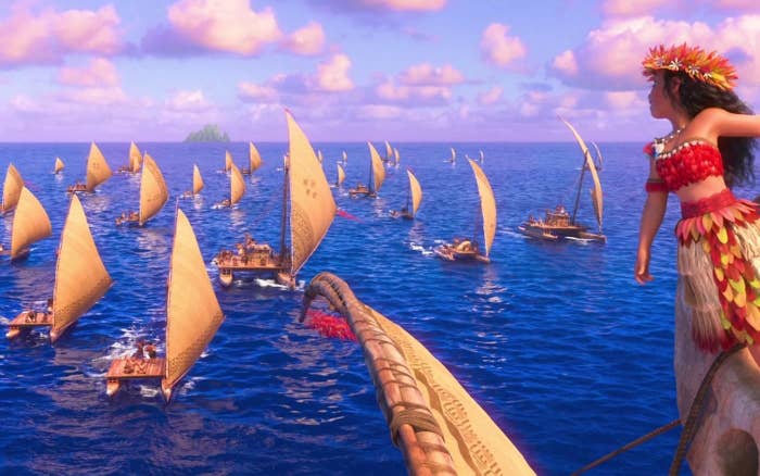 moana stands on a boat on the ocean
