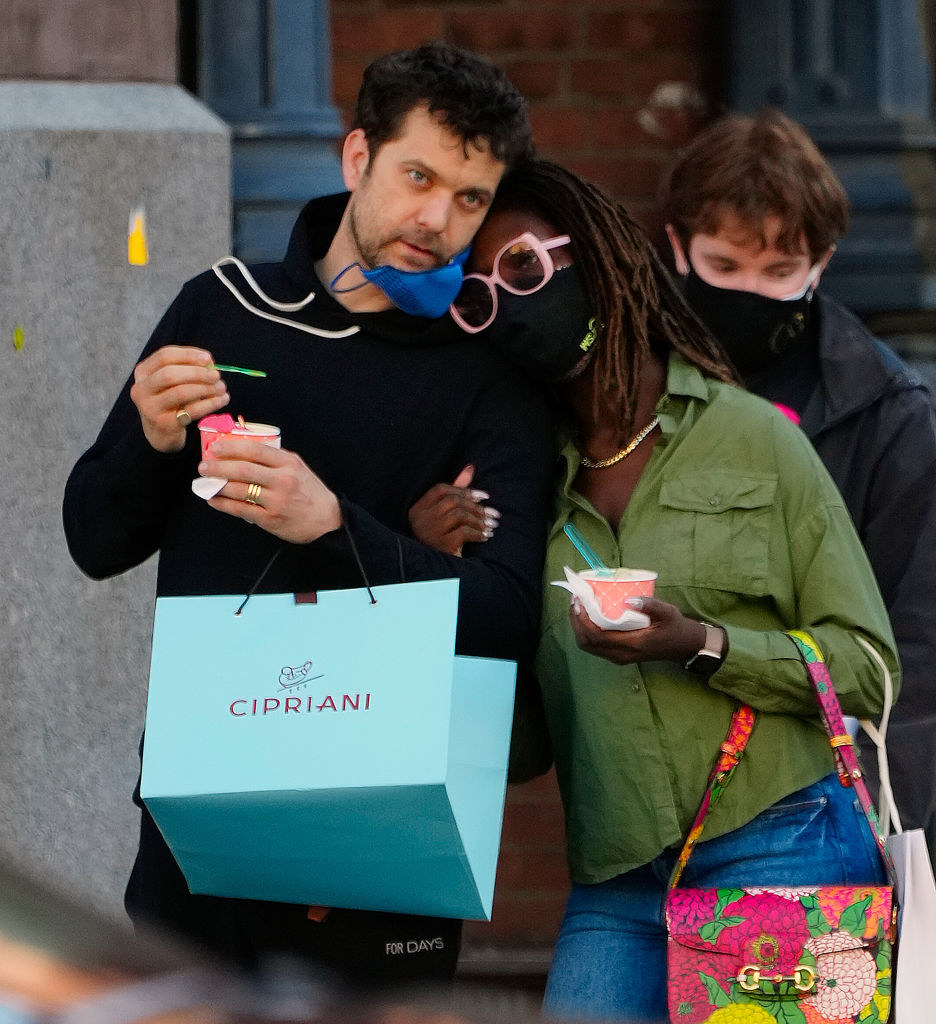 Joshua and Jodie arm-in-arm and holding shopping bags and wearing masks