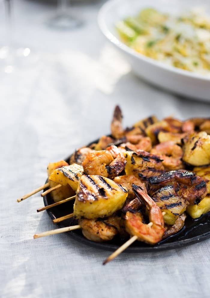 Grilled shrimp skewers with pineapple chunks.