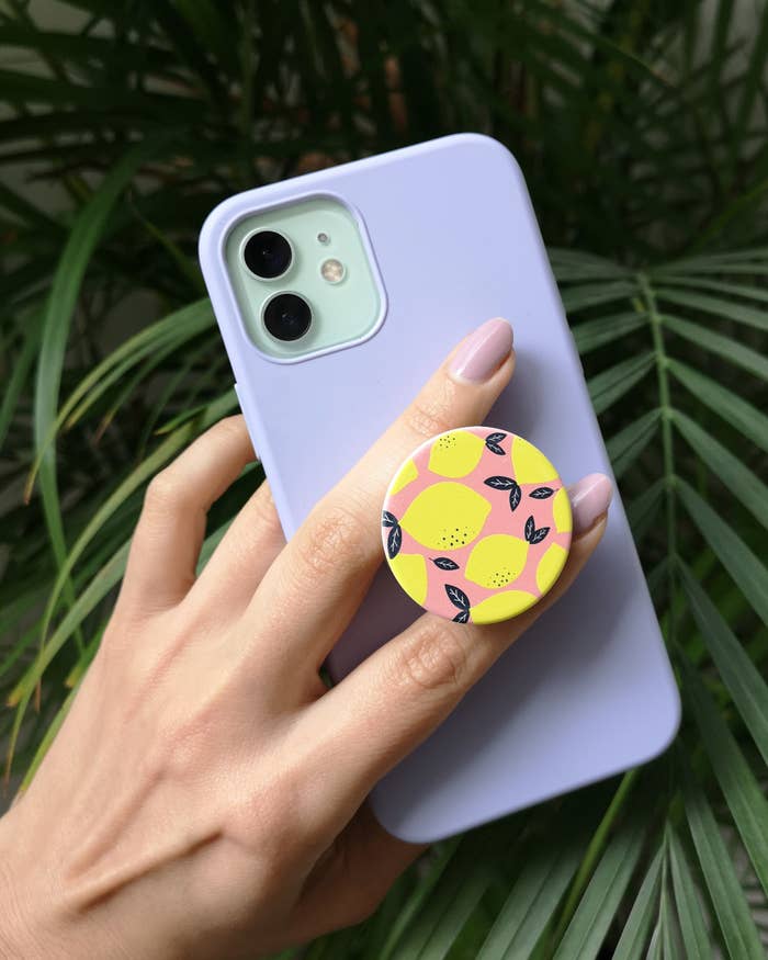 Brittany holding her iPhone 12 with the lemon-patterned popsocket 