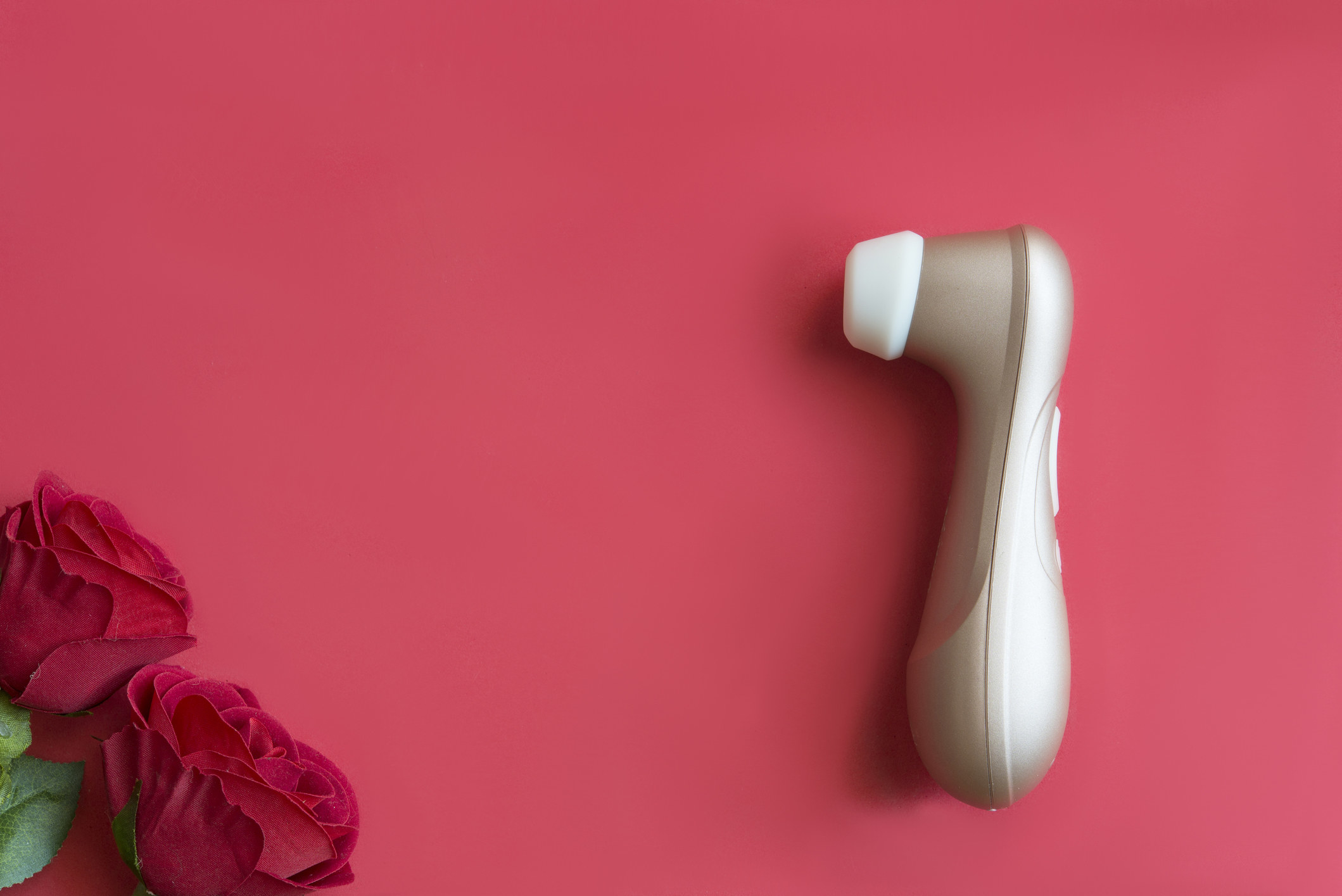 An image of a sex toy on a red background with roses
