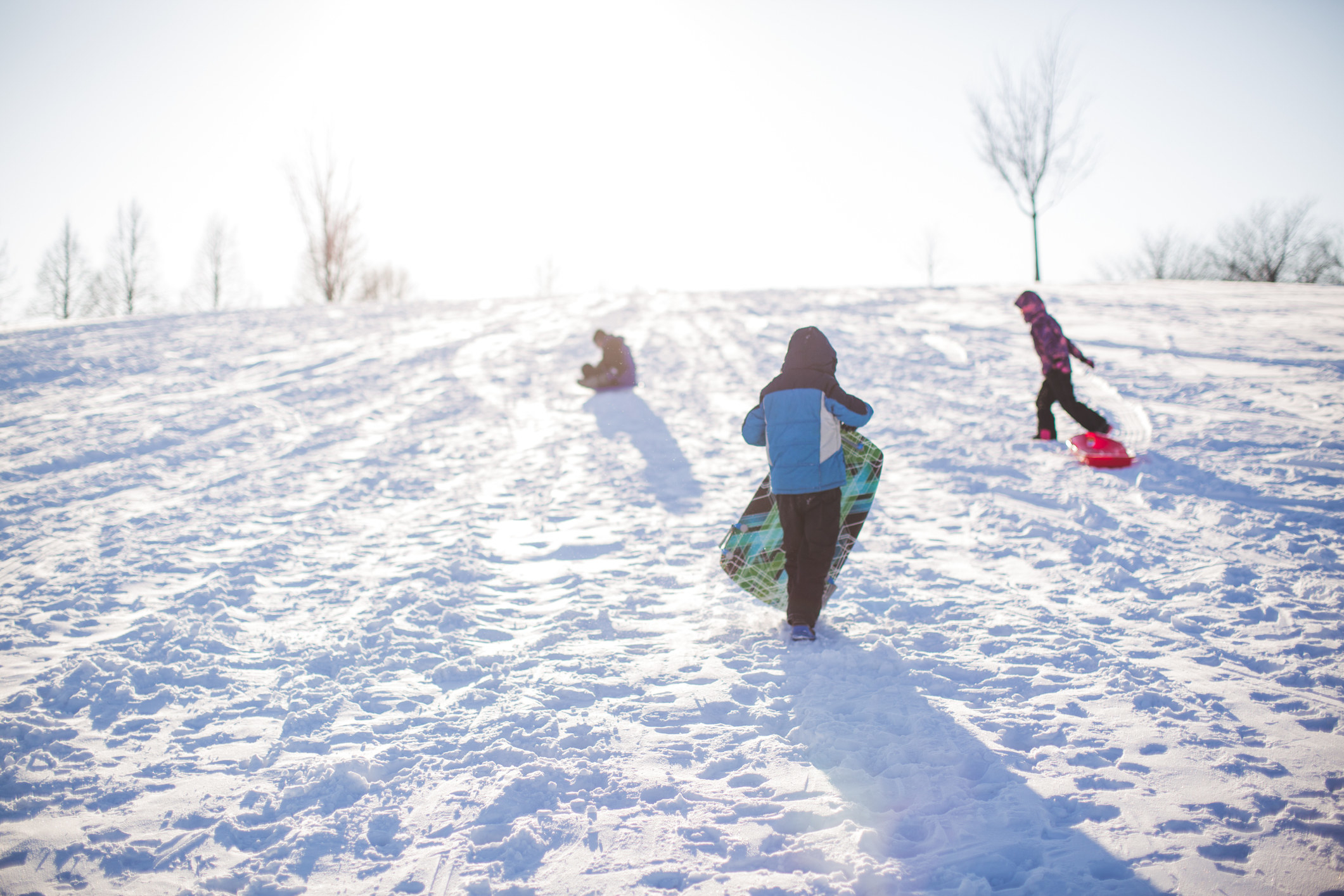 Three kids playing in snow.