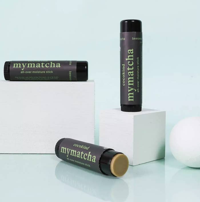 Open tube of my matcha laying down next to another tube placed on a block