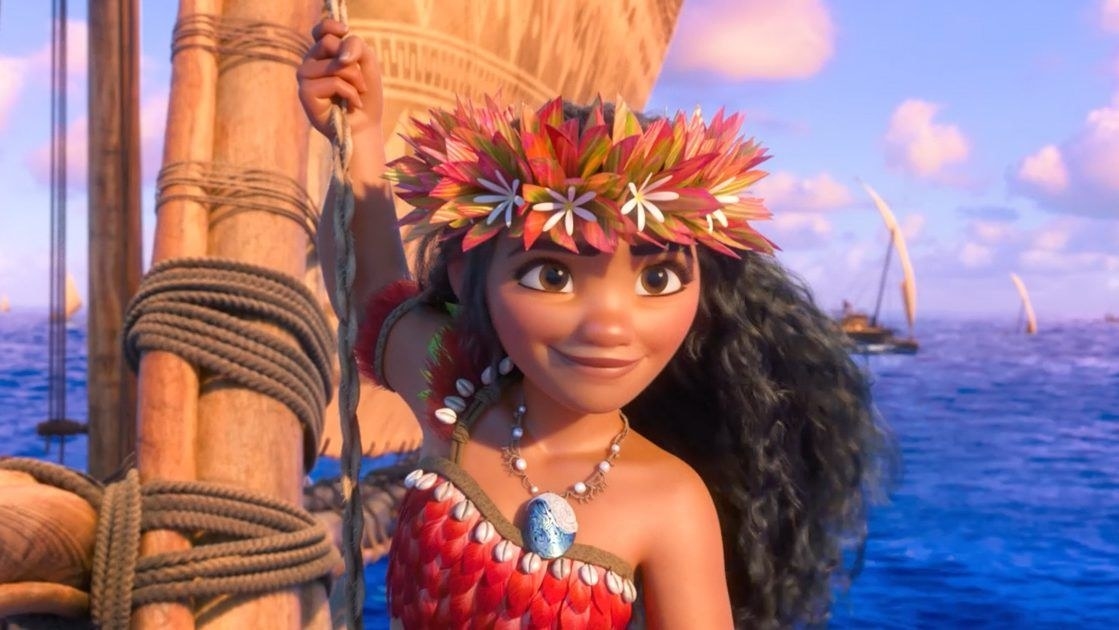 moana stands on a boat while on the ocean