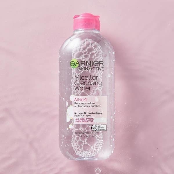 Bottle of Garnier micellar water against pink background