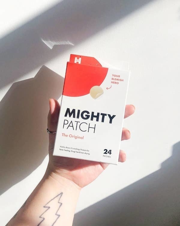 Hand holding Mighty Patch acne patches