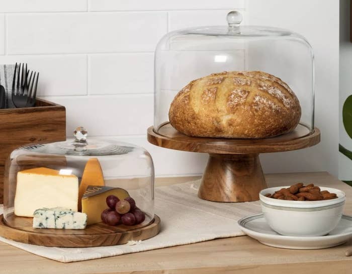 Cake platters displaying cheese and bread