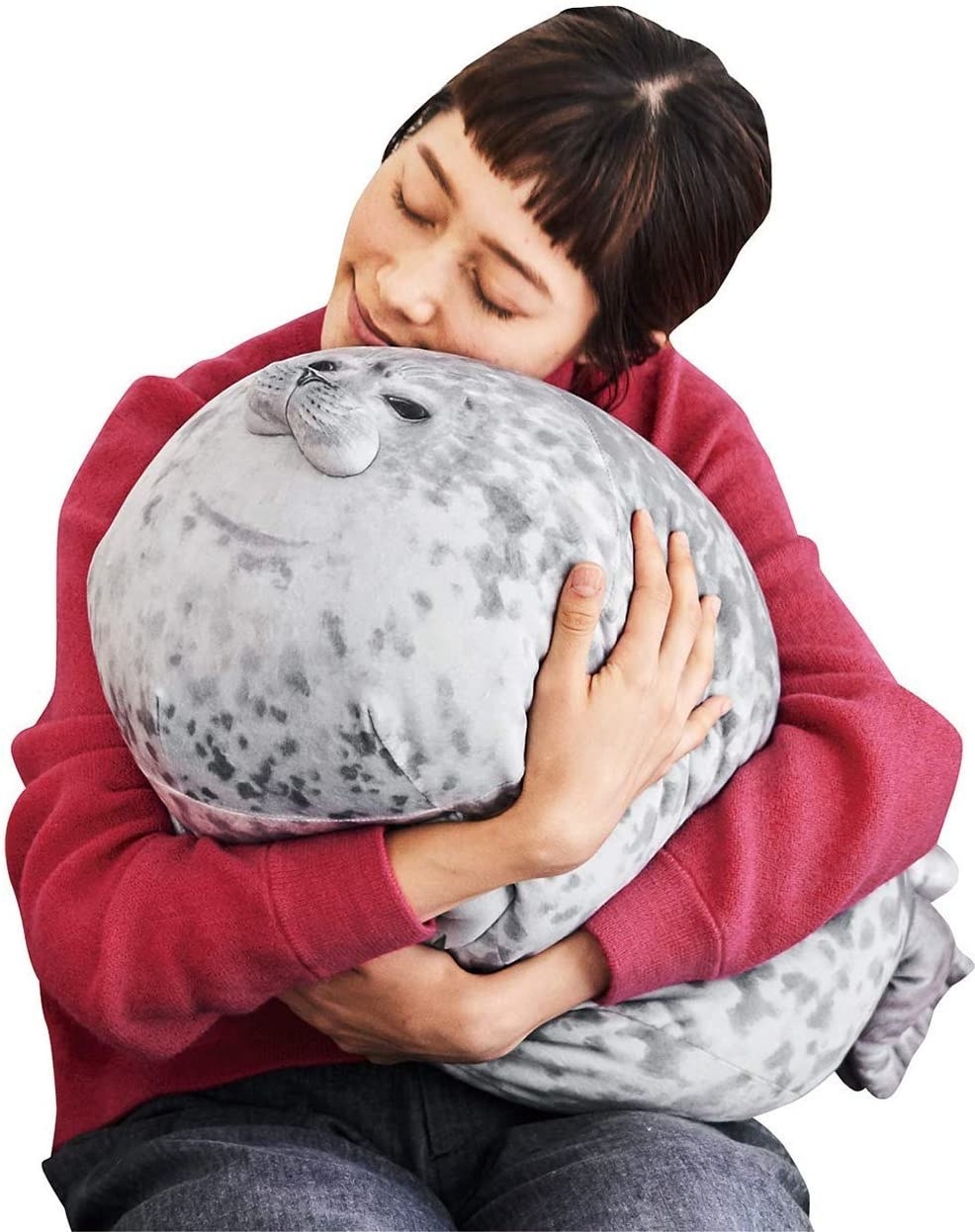 A model hugs the stuffed seal