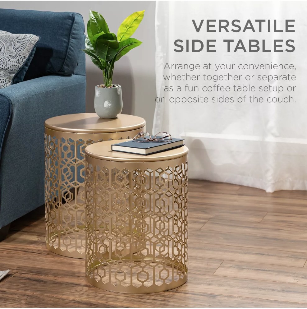A set of two, gold nesting tables with an intricate design and solid gold tops
