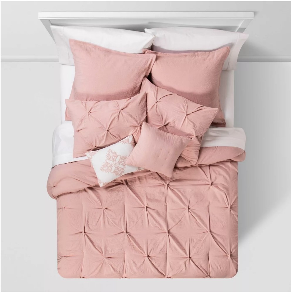 An 8-piece comforter set in blush