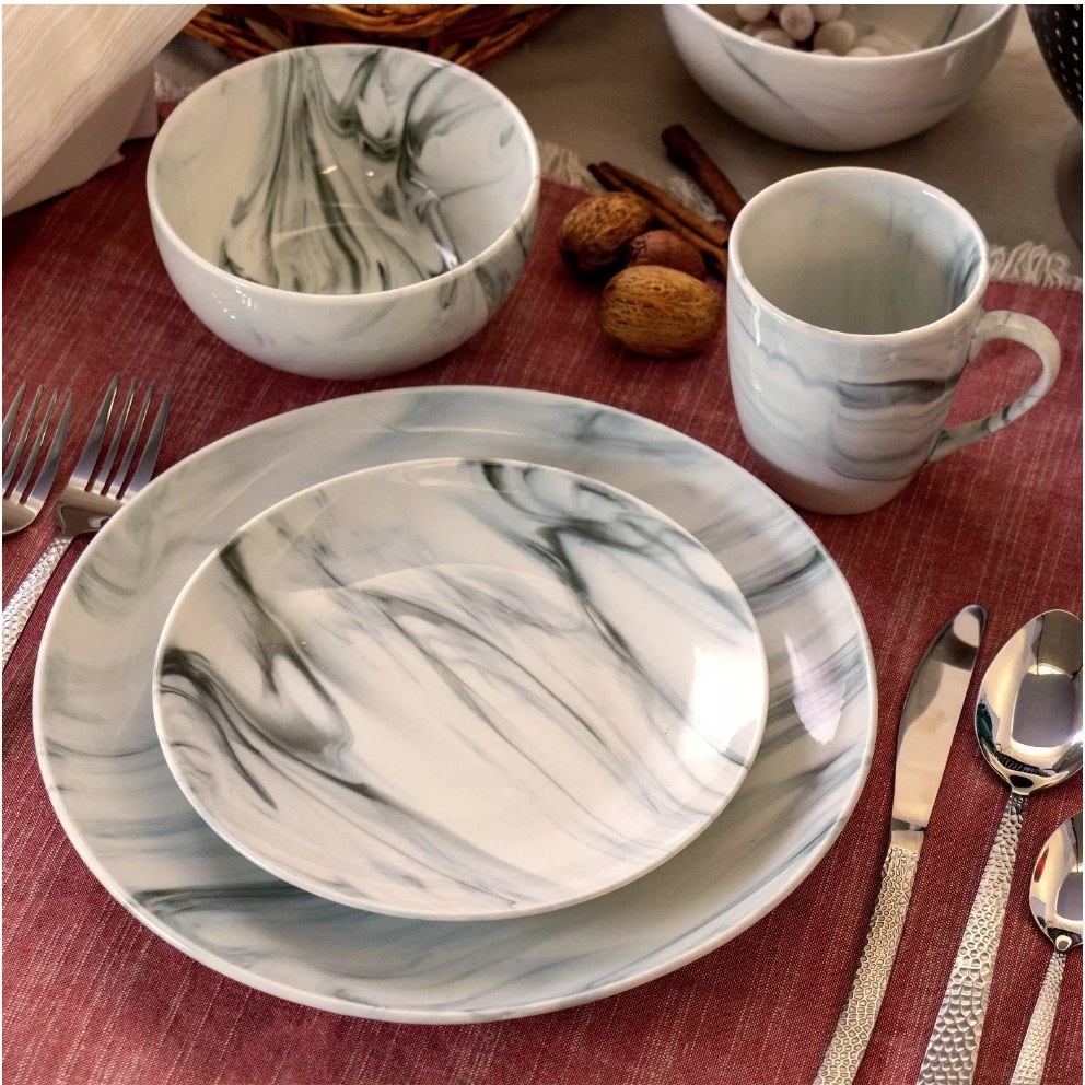 A 16-piece, stoneware, marble dinnerware set displayed on a table