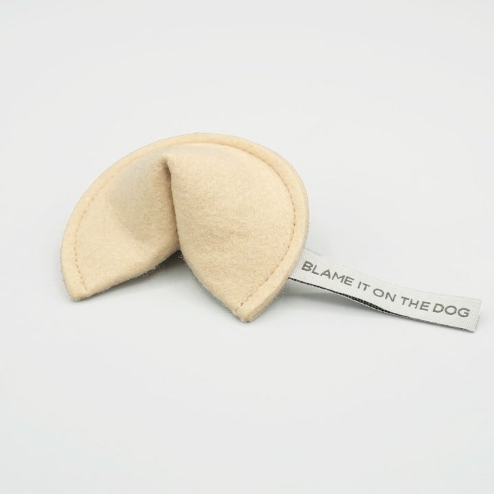 the fortune cookie-shaped toy which has a tag that says "blame it on the dog"