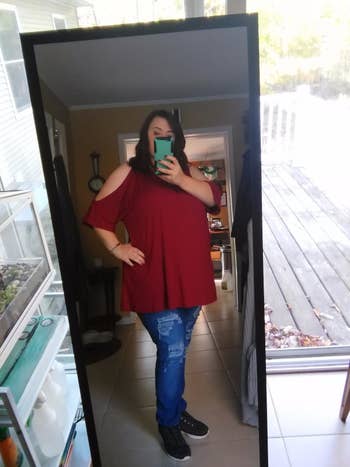 image of reviewer wearing the wine red cold shoulder top with jeans