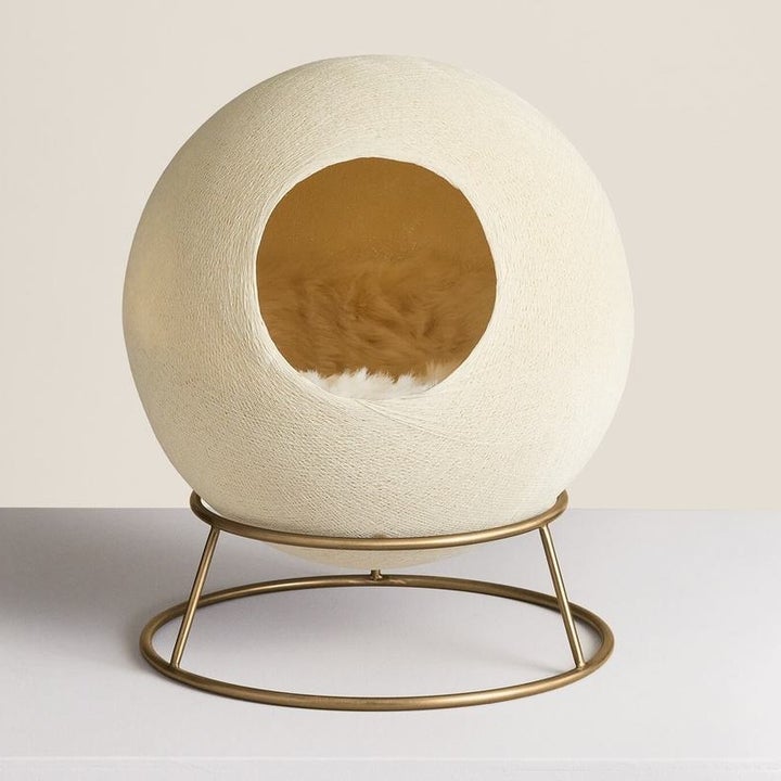 the spherical bed with a faux-fur blanket inside