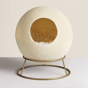 the spherical bed with a faux-fur blanket inside
