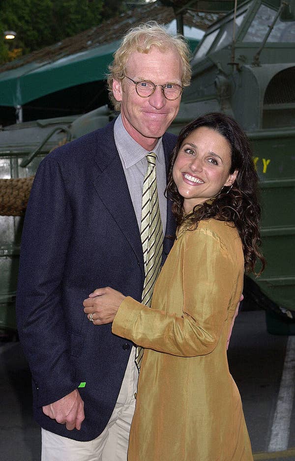 Brad Hall and Julia Louis-Dreyfus in a deep embrace