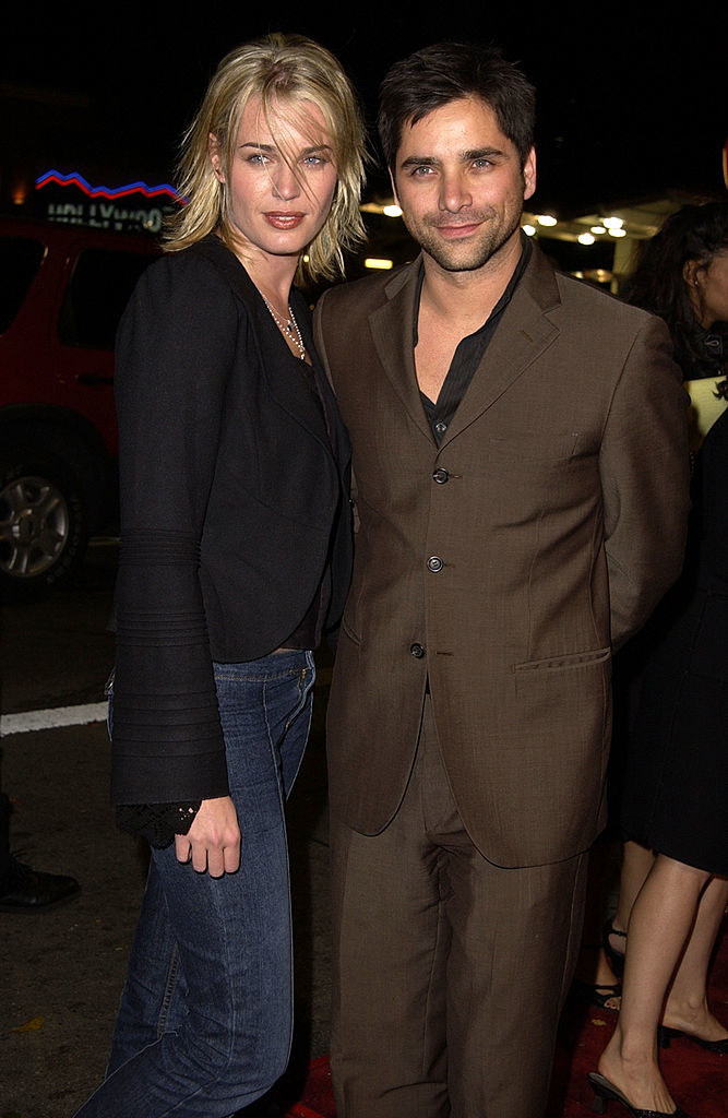 Rebecca Romijn and John Stamos at a movie premiere