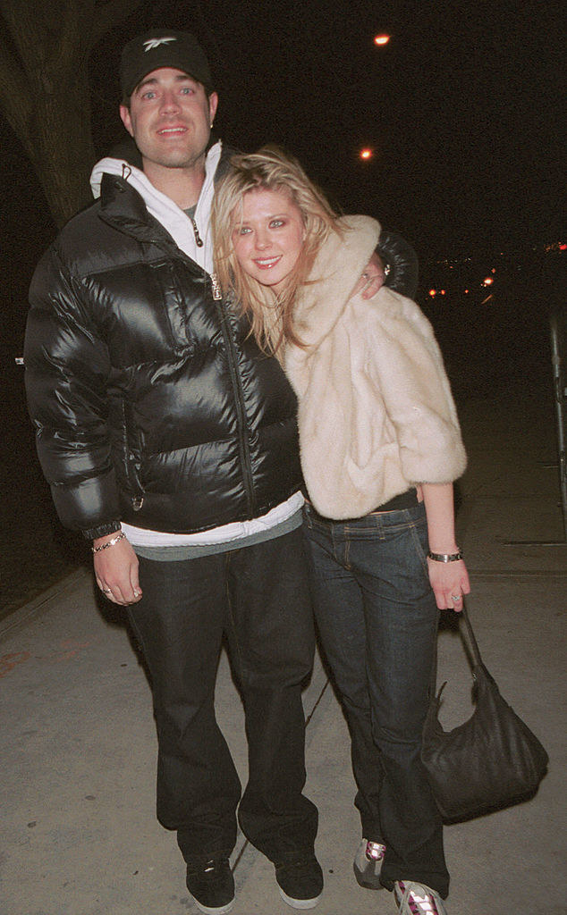 Carson Daly and Tara Reid smiling on a sidewalk