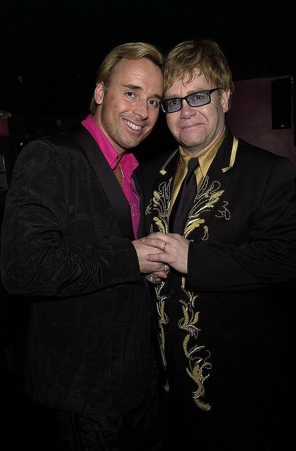 David Furnish and Elton John holding hands
