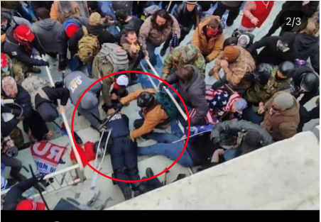 In this aerial view of a mob, a circle is drawn around someone in a crowd standing over an officer lying prone on the ground