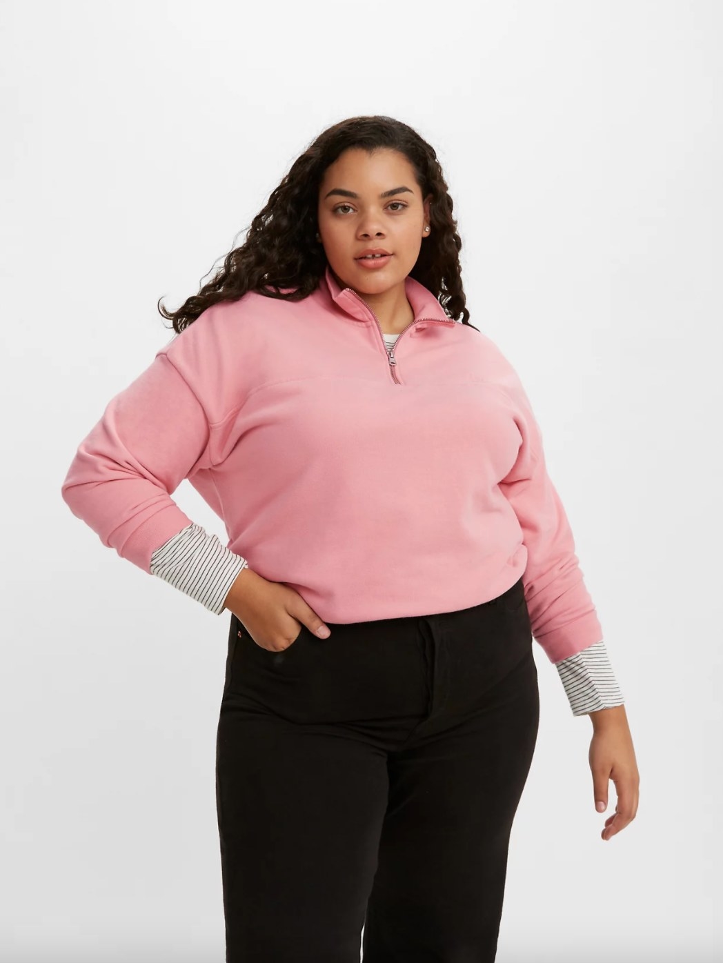 The quarter-zip sweatshirt on a model in blush pink