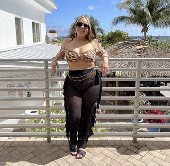 reviewer wearing the sheer pants with swimsuit