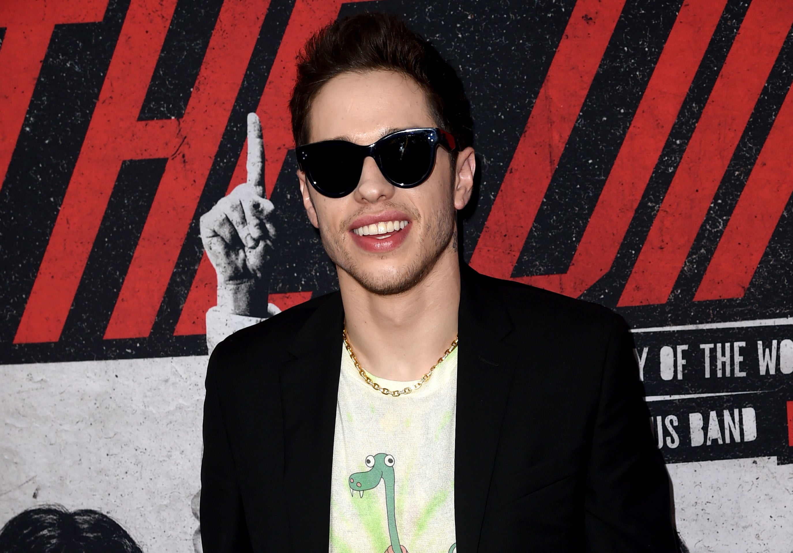 Pete wears sunglasses and a dinosaur T-shirt to an event