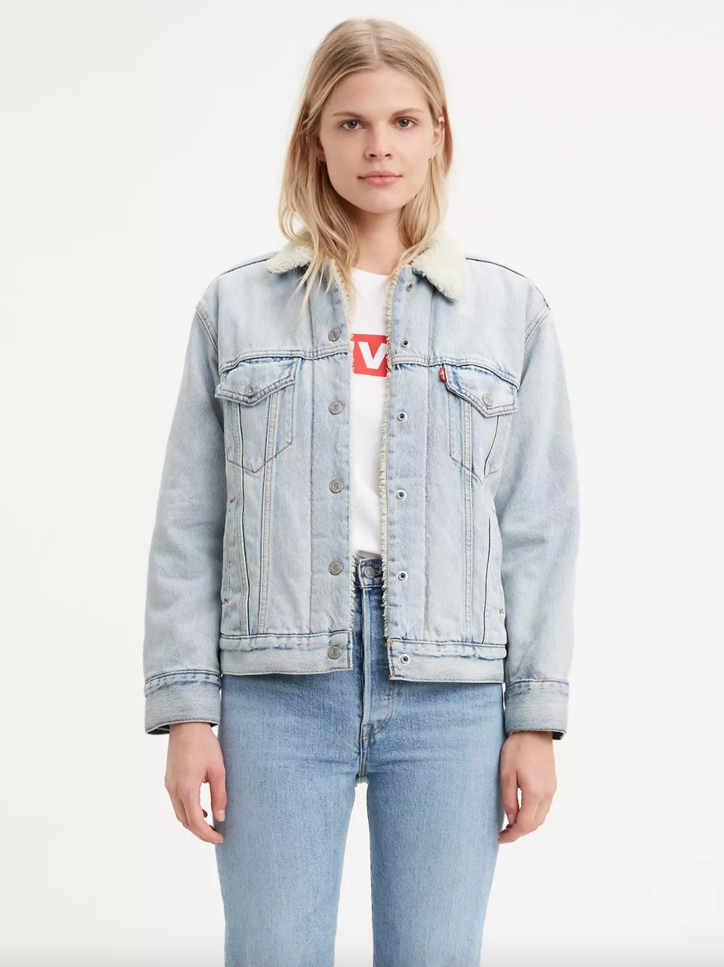 The sherpa trucker jacket a model in a white tee and jeans