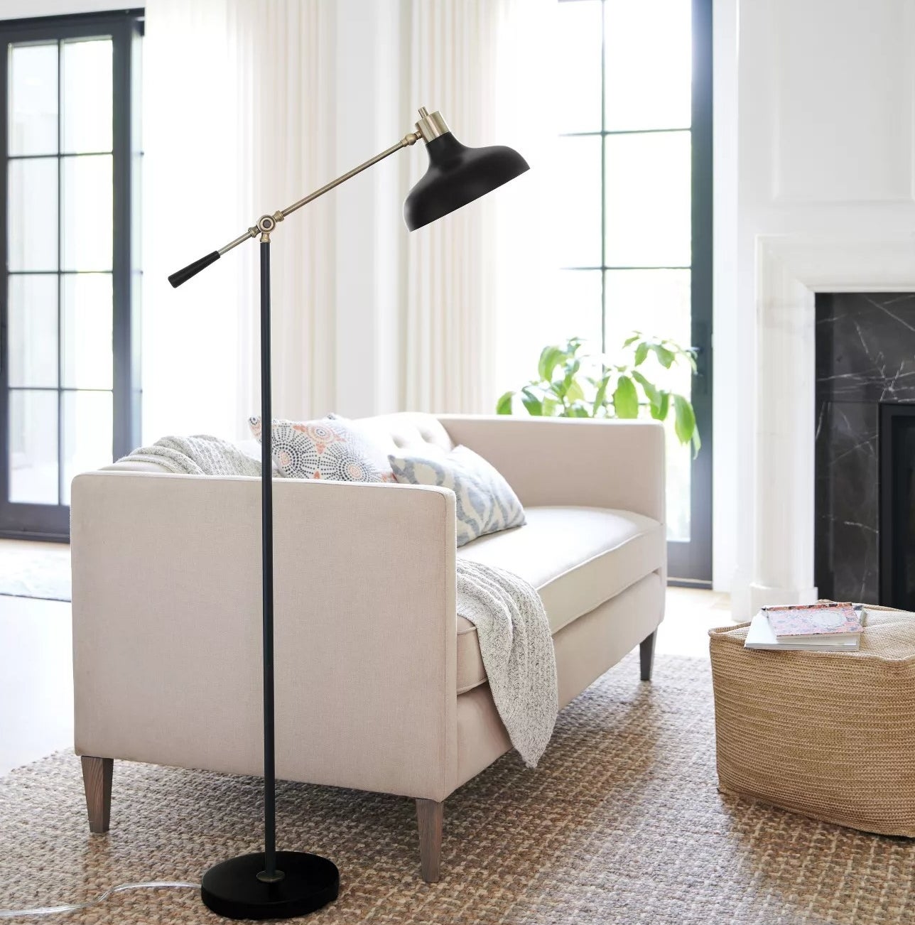The lamp with an adjustable arm and circular base in a living room