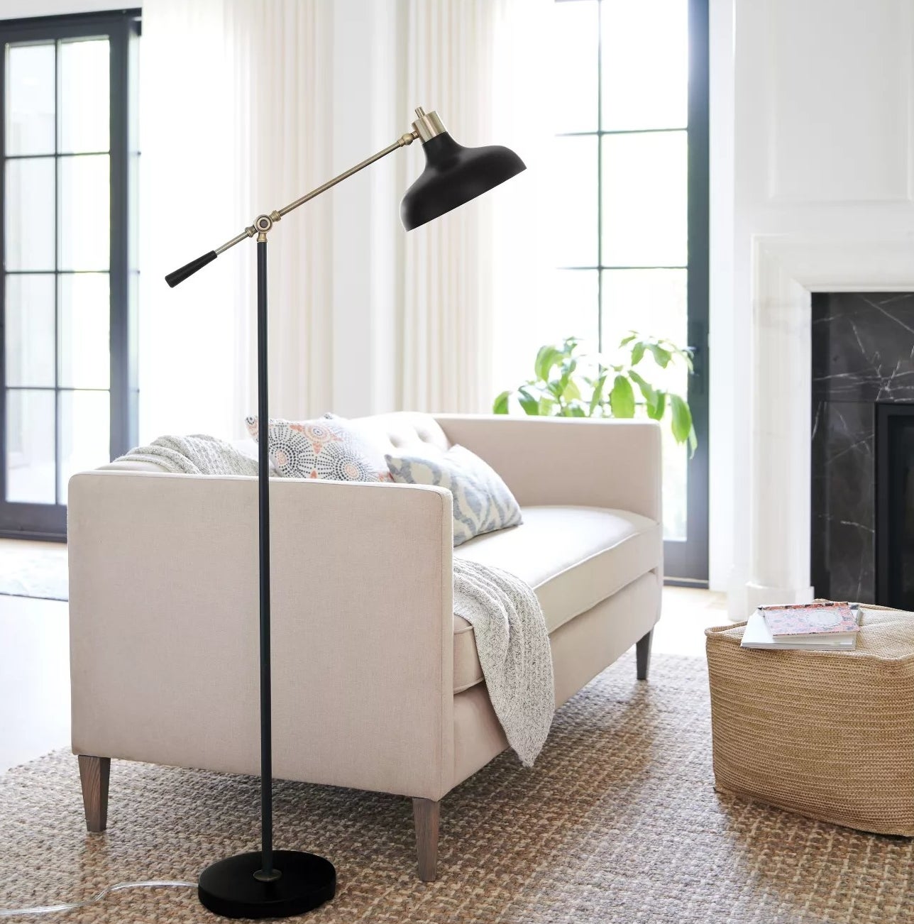 The lamp with an adjustable arm and circular base in a living room