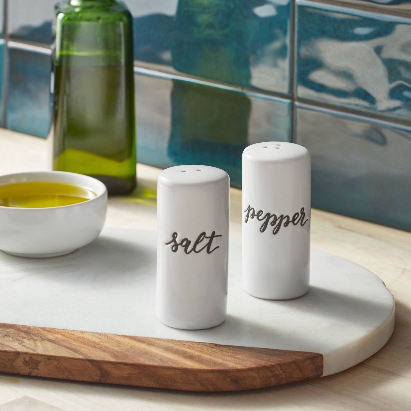 white stoneware salt and pepper shakers with &quot;salt&quot; and &quot;pepper&quot; on front