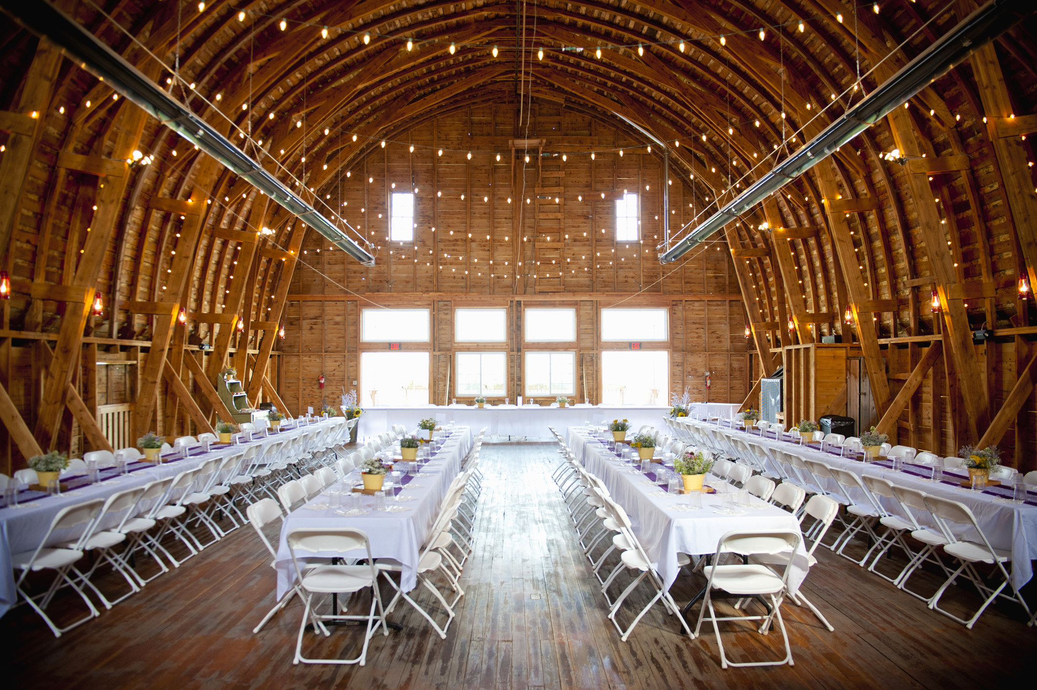 A barn interior setup for a wedding reception