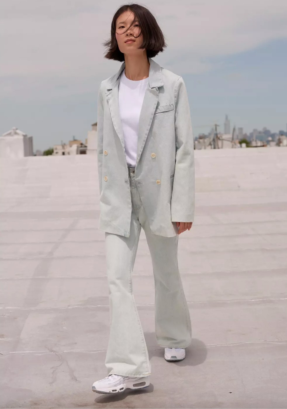 The winter sports coat in freshies lightwash being worn by a model on a rooftop