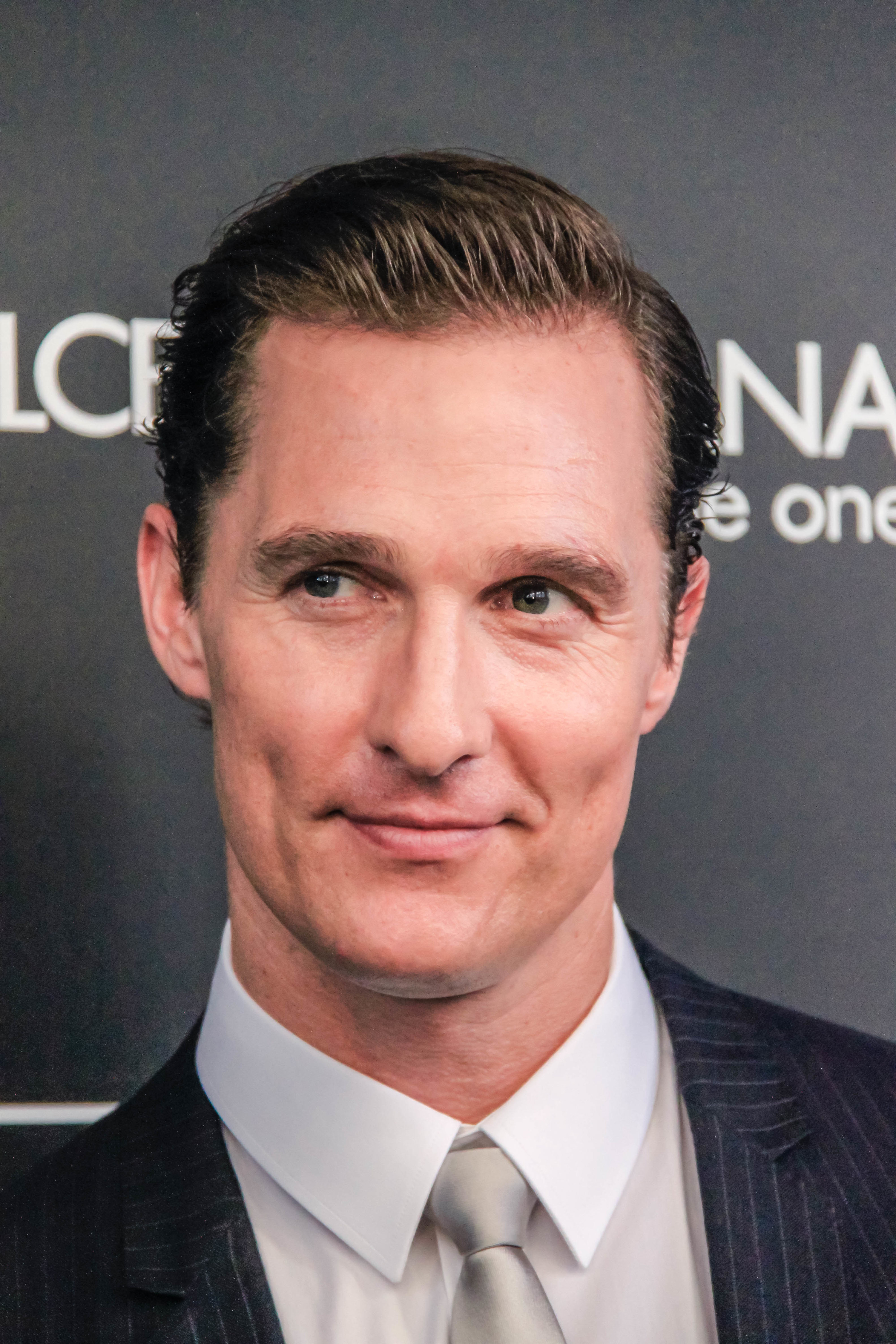 Photo of Matthew McConaughey in a suit with slicked back hair