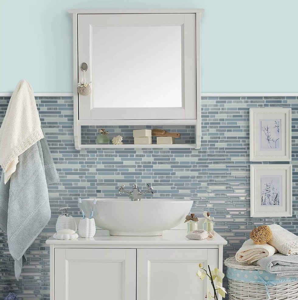3D, blue and gray, peel and stick bathroom tiles displayed over a vanity in a bathroom 