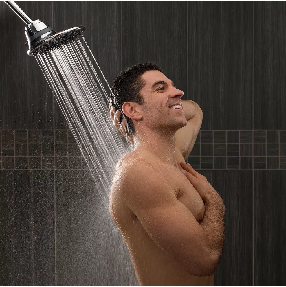 A 7-mode, rainfall shower head being used by a model