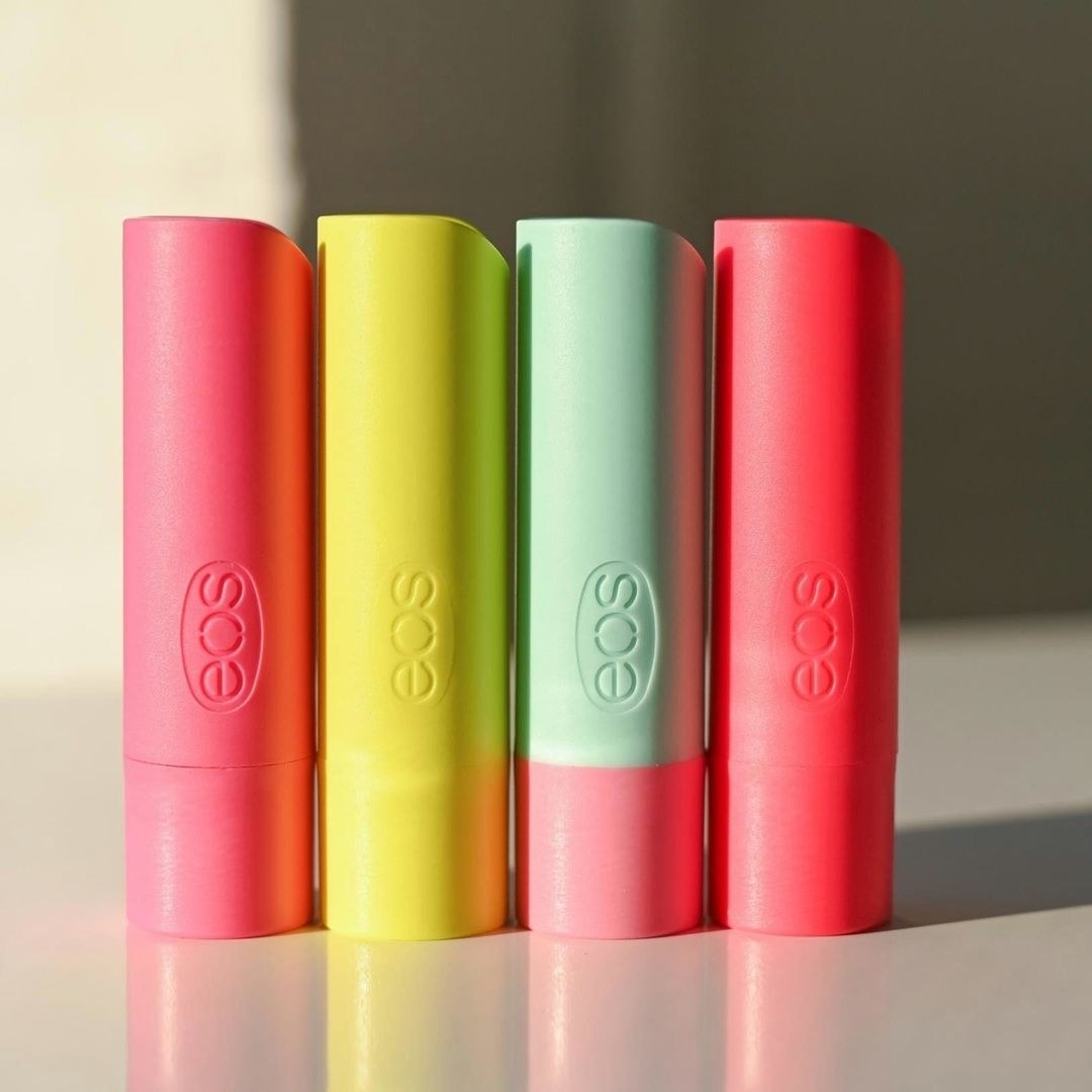 Four eos lip balms standing next to each other