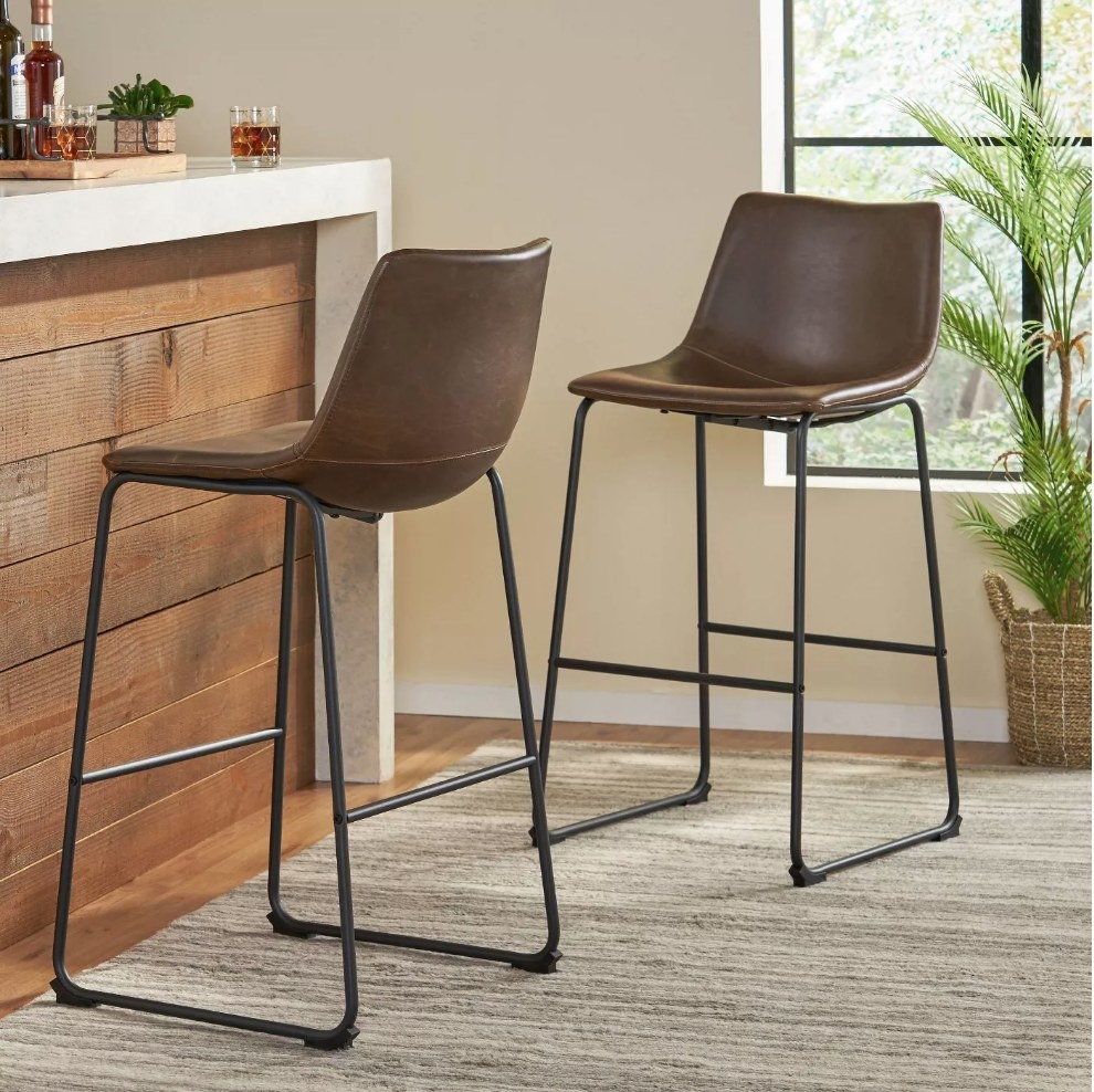 Two, 30&quot; faux brown leather bar chairs at a kitchen island