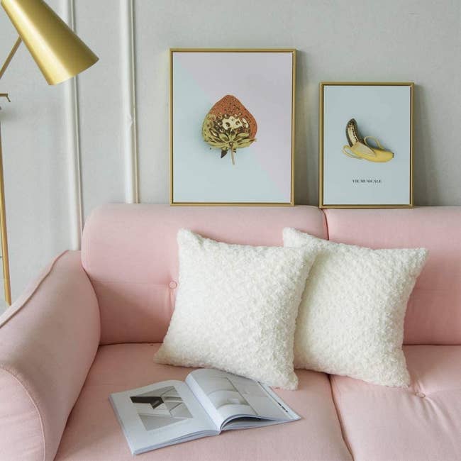 plush faux fur white pillows on a baby pink couch