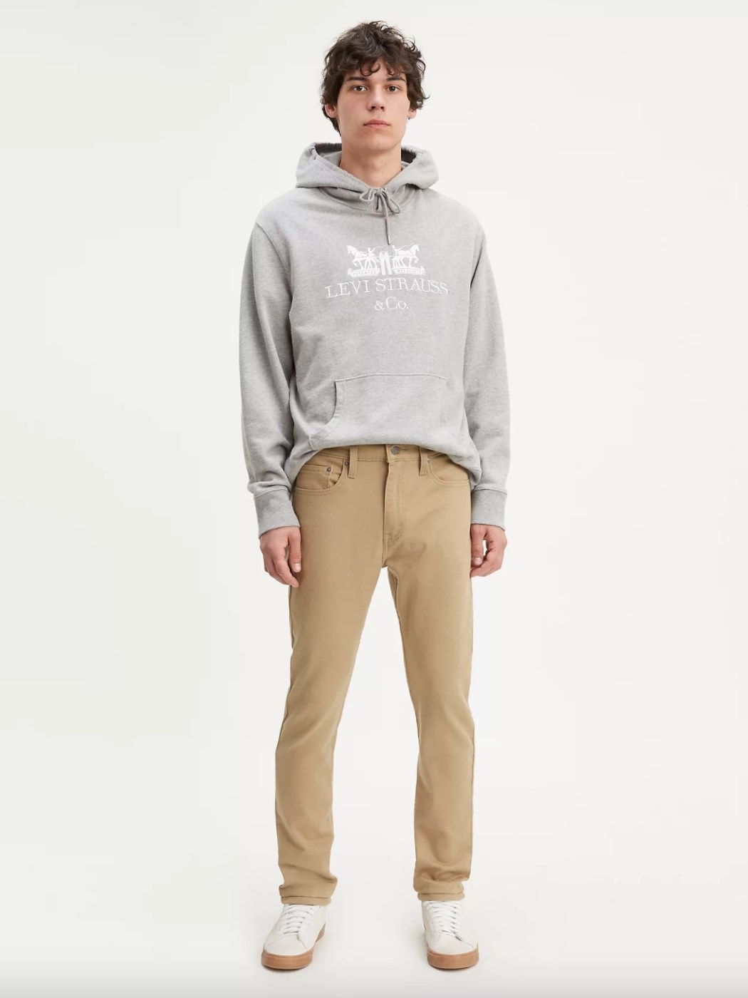 A model wearing the khaki pants and a gray hoodie