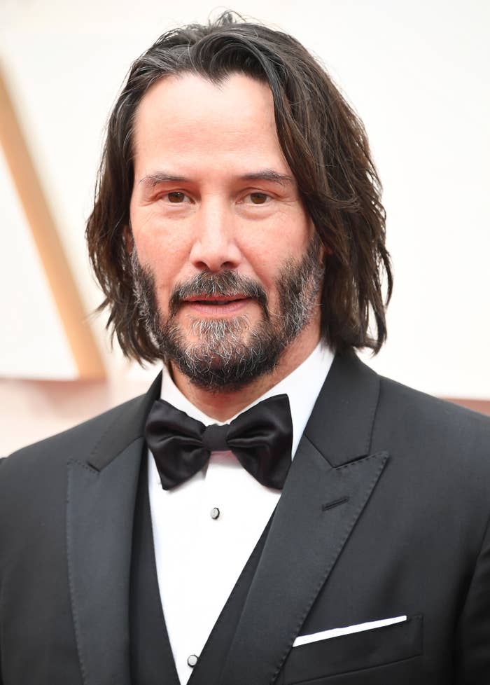 Photo of Keanu Reeves in a classic three-piece suit and bow-tie