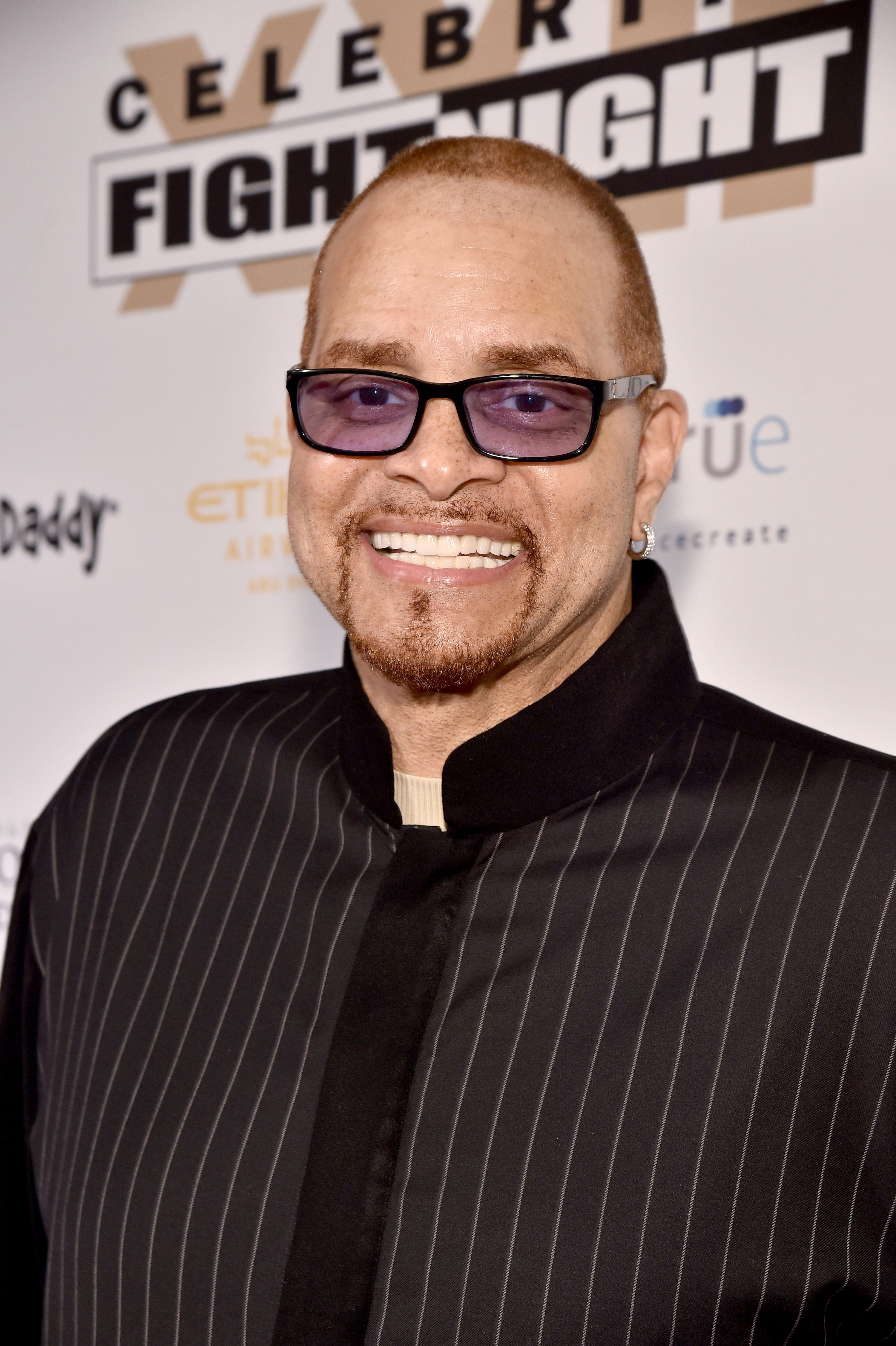 Photo of comedian Sinbad in a pin-striped jacket and black glasses 