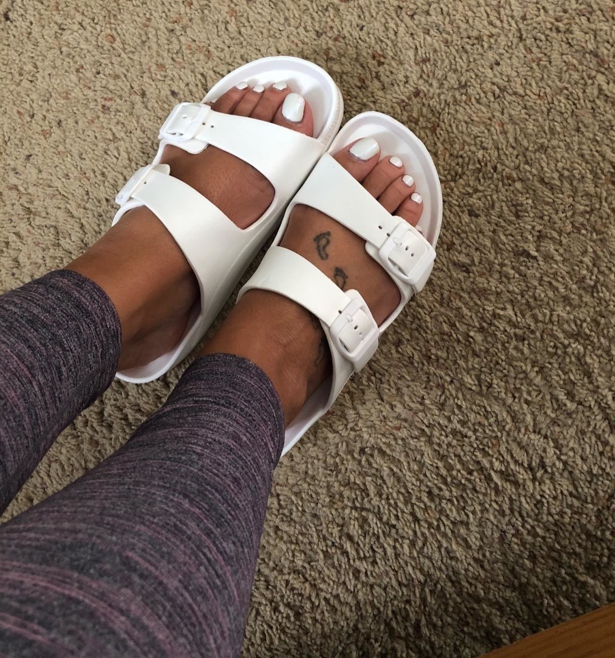 reviewer wearing sandals in white