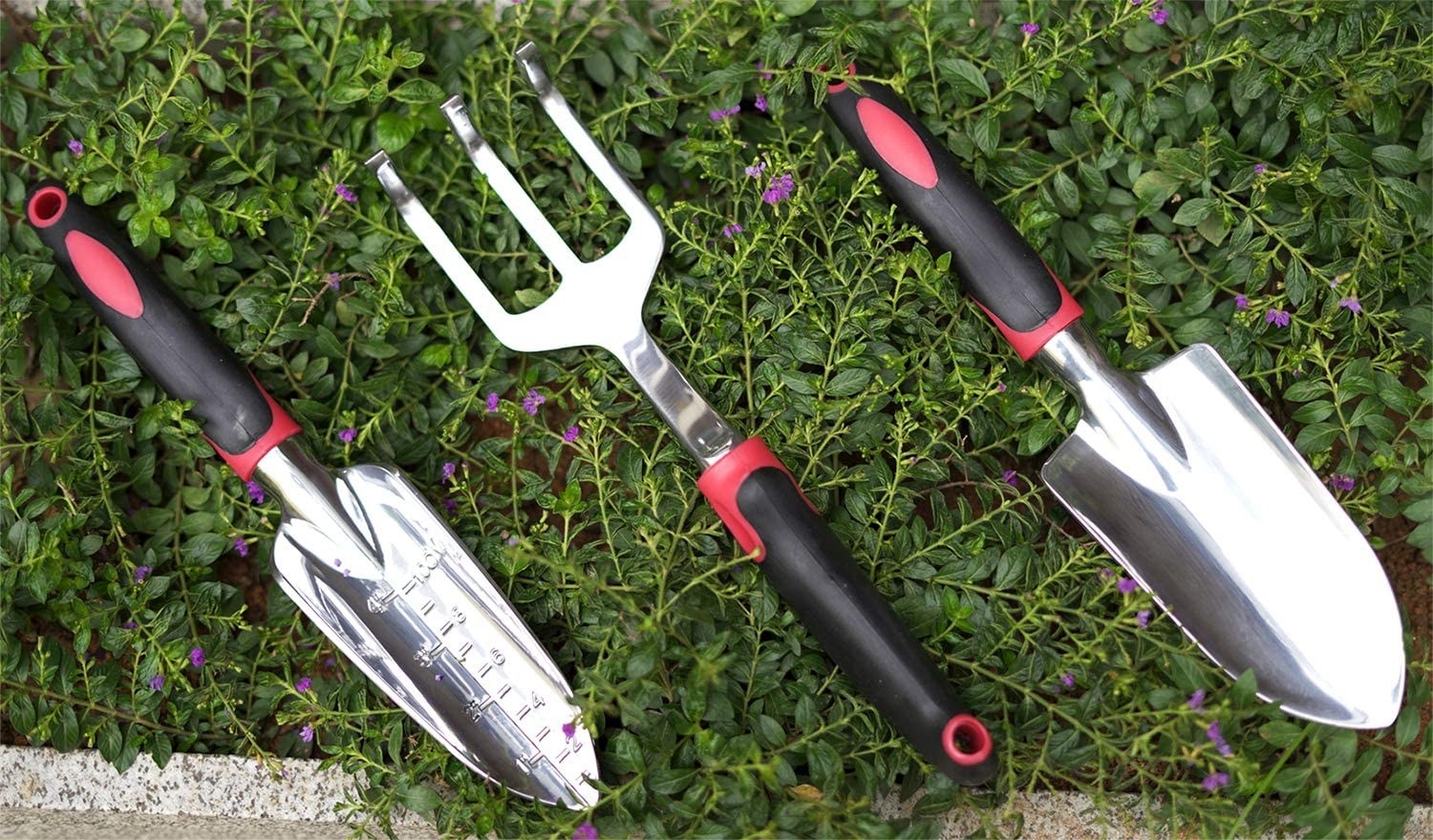 the two trowels and hand rake in the grass