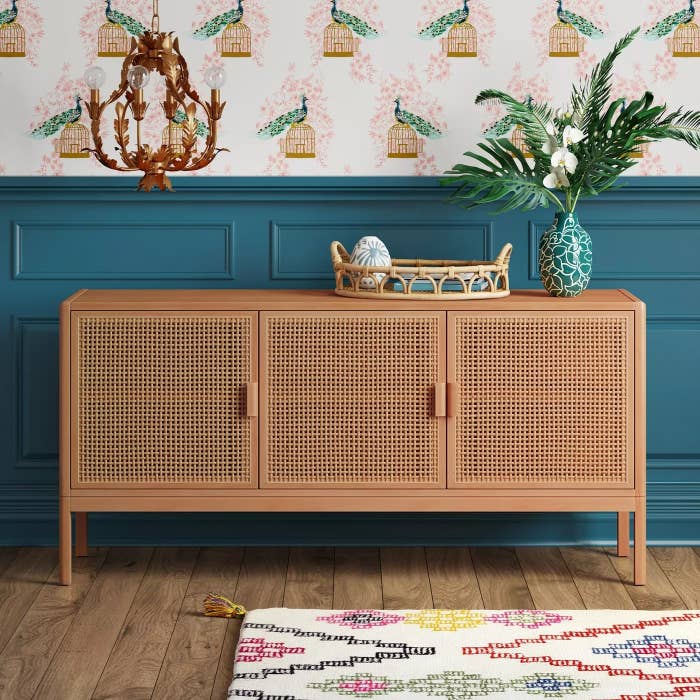 The brown wooden sideboard with three mesh doors