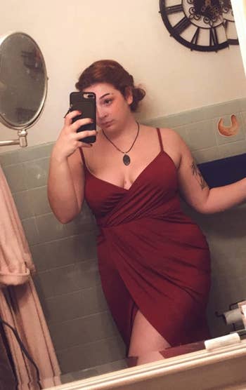 Reviewer taking a selfie in the red dress