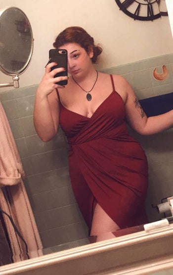 Reviewer taking a selfie in the red dress