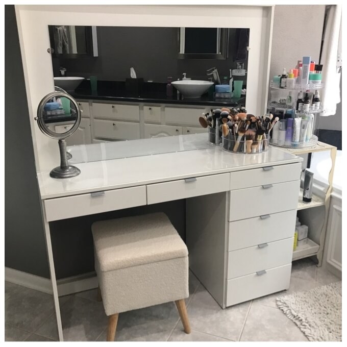 A reviewer&#x27;s white vanity holding makeup and toiletries
