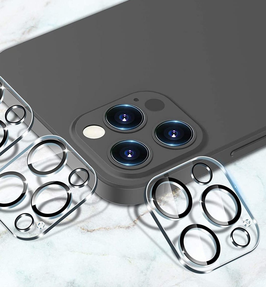 Three lens covers leaning on an iPhone